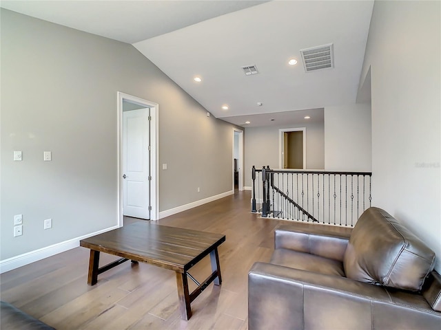 8491 Pippen Dr, Orlando, FL 32836 - living room featuring wood finished floors, baseboards, lofted ceiling, and recessed lighting