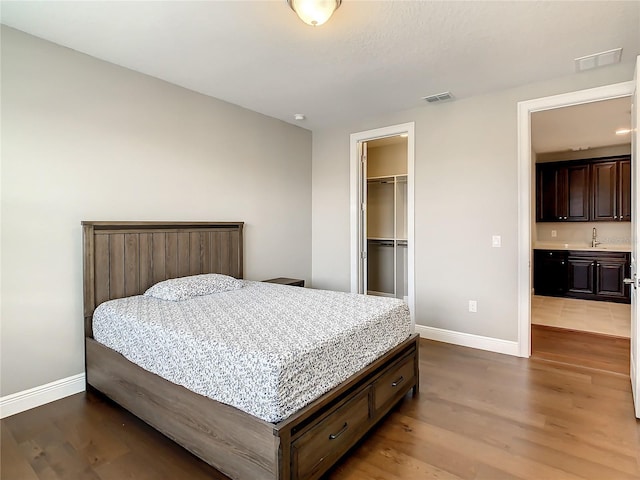 8491 Pippen Dr, Orlando, FL 32836 - bedroom with baseboards, wood finished floors, and bar with sink