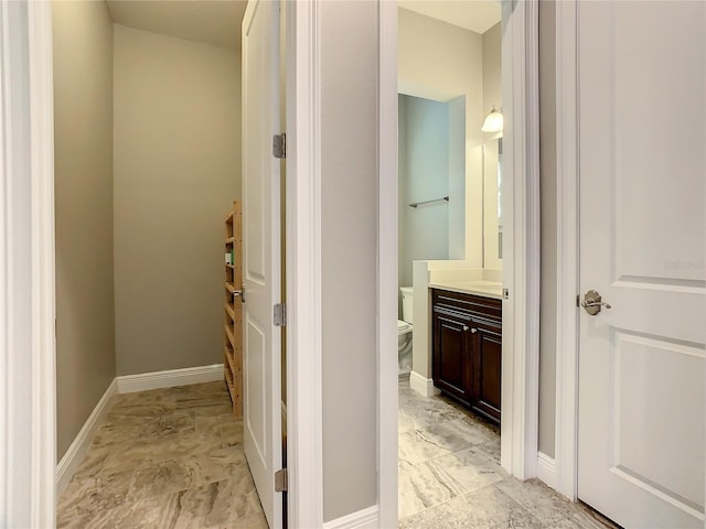 8491 Pippen Dr, Orlando, FL 32836 - hallway featuring light marble finish floors and baseboards