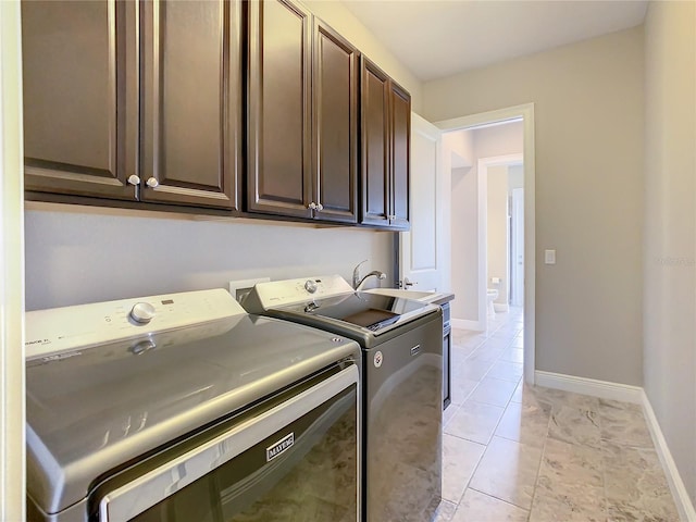8491 Pippen Dr, Orlando, FL 32836 - washroom with cabinet space, washer and clothes dryer, and baseboards