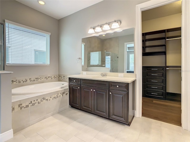 8491 Pippen Dr, Orlando, FL 32836 - full bathroom with a shower stall, a garden tub, tile patterned flooring, vanity, and recessed lighting