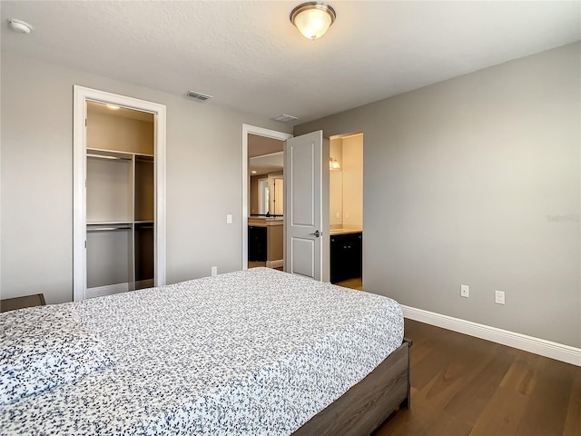 8491 Pippen Dr, Orlando, FL 32836 - bedroom featuring dark wood-style floors, baseboards, and a closet