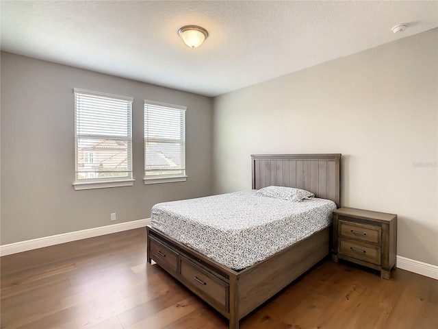 8491 Pippen Dr, Orlando, FL 32836 - bedroom with dark wood-style flooring and baseboards