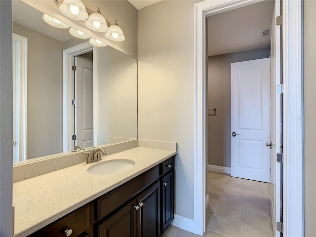 8491 Pippen Dr, Orlando, FL 32836 - bathroom with baseboards, vanity, and tile patterned flooring