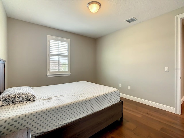 8491 Pippen Dr, Orlando, FL 32836 - bedroom with dark wood-type flooring and baseboards