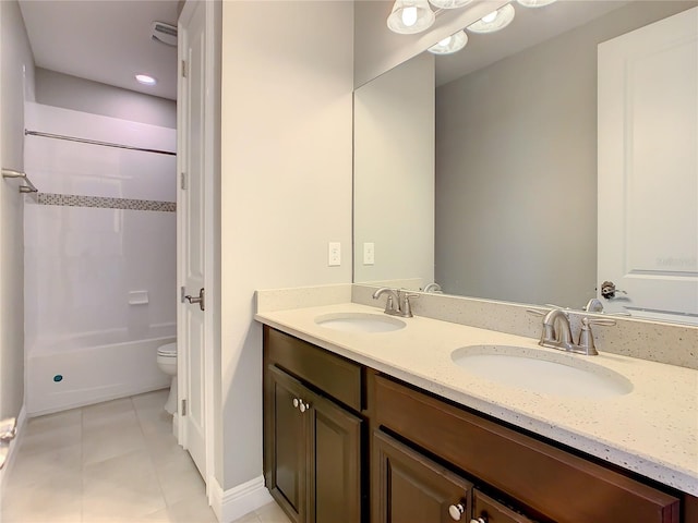 8491 Pippen Dr, Orlando, FL 32836 - bathroom featuring double vanity, tile patterned flooring, baseboards, and toilet