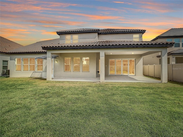 8491 Pippen Dr, Orlando, FL 32836 - back of property at dusk with a patio and stucco siding