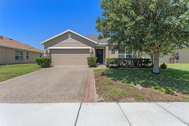 view of front facade with a garage, driveway, a front yard, and stucco siding
