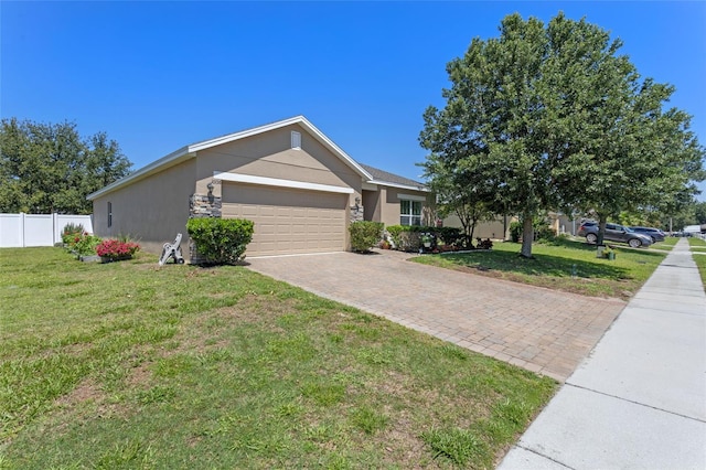 view of front facade with stucco siding, an attached garage, and decorative driveway
