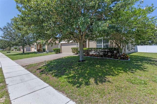obstructed view of property featuring driveway, a garage, and stucco siding
