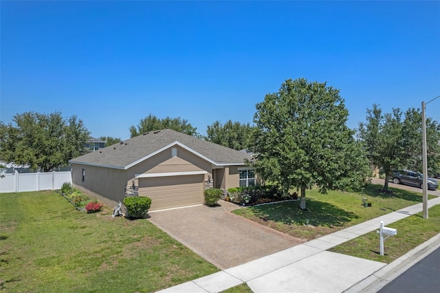 ranch-style home with stucco siding, a garage, and driveway