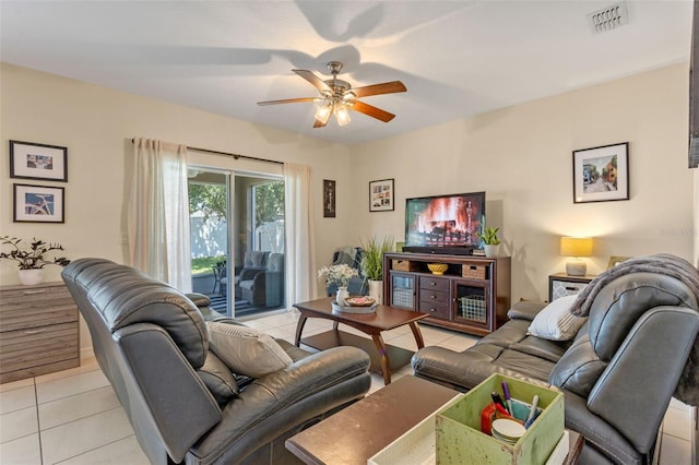 living room featuring light tile patterned floors and a ceiling fan