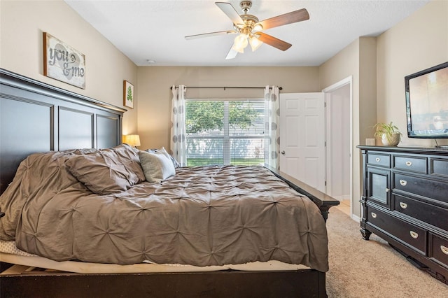 bedroom with light carpet and ceiling fan