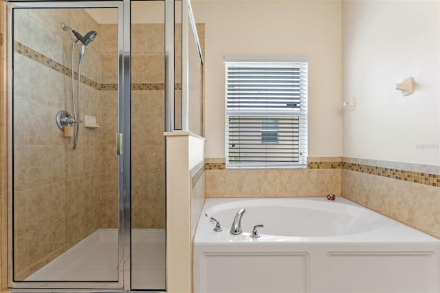 full bath featuring a shower stall and a garden tub