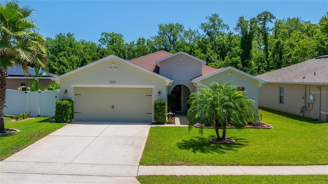 view of front of house featuring a garage, driveway, and stucco siding