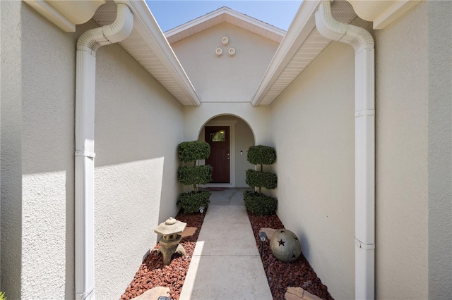view of exterior entry with stucco siding