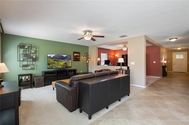 living room with a ceiling fan and light tile patterned floors