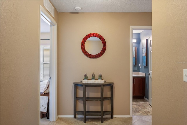 corridor featuring a textured ceiling