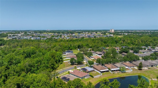 aerial view of property's location with a nearby body of water and nearby suburban area