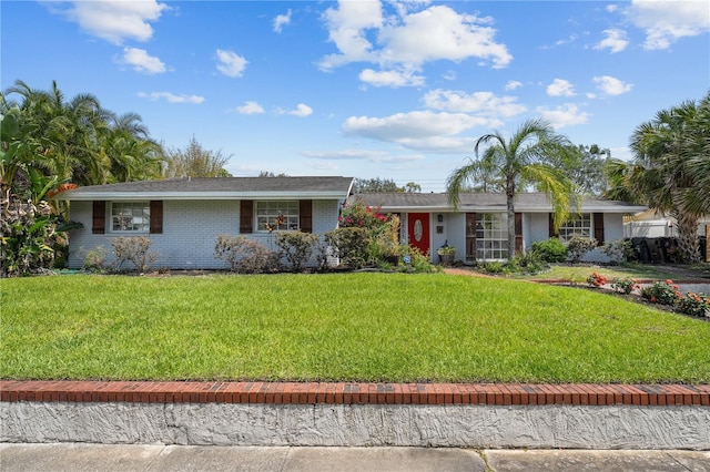 ranch-style house featuring brick siding and a front yard