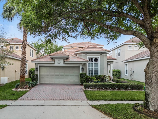 8333 Via Verona, Orlando, FL 32836 - mediterranean / spanish-style home featuring stucco siding, a tiled roof, decorative driveway, and an attached garage