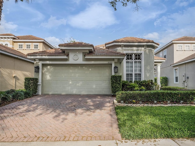 8333 Via Verona, Orlando, FL 32836 - mediterranean / spanish home featuring decorative driveway, stucco siding, an attached garage, and a tile roof