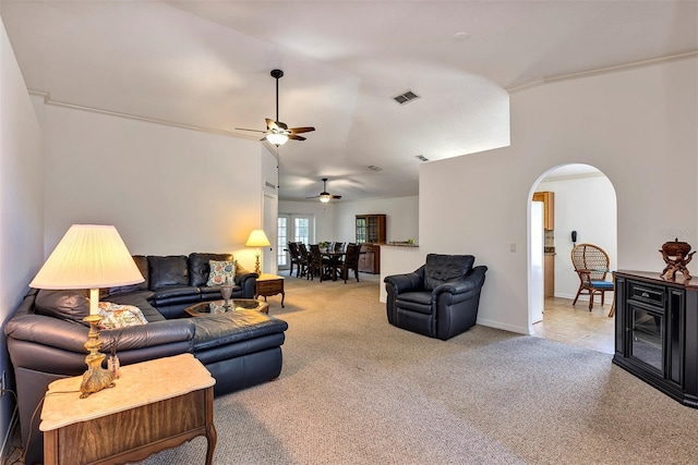 638 Sun Bluff Ln, Apopka, FL 32712 - carpeted living room with arched walkways, ceiling fan, baseboards, and lofted ceiling