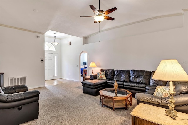 638 Sun Bluff Ln, Apopka, FL 32712 - carpeted living area with a ceiling fan, arched walkways, baseboards, crown molding, and a high ceiling