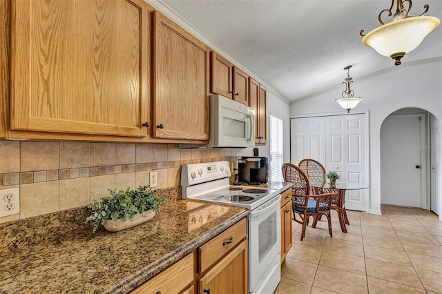 638 Sun Bluff Ln, Apopka, FL 32712 - kitchen featuring white appliances, arched walkways, lofted ceiling, backsplash, and crown molding