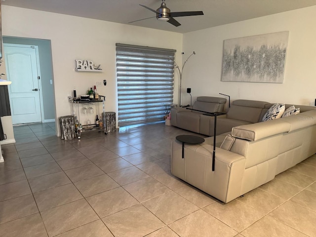 living room with a ceiling fan and light tile patterned floors