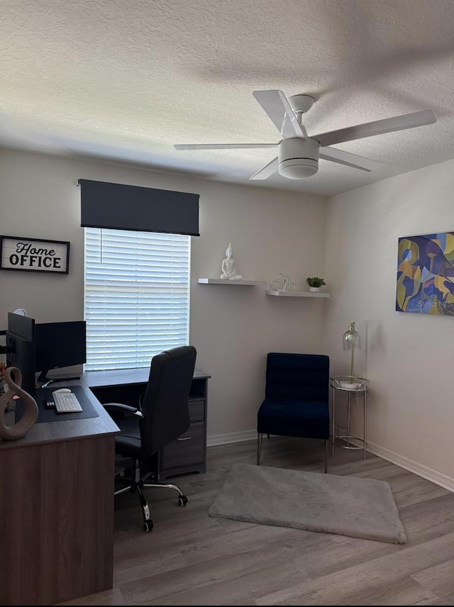 office with a textured ceiling, a ceiling fan, wood finished floors, and baseboards