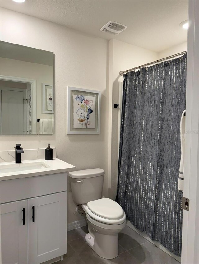 full bathroom with toilet, tile patterned flooring, vanity, and a shower with shower curtain