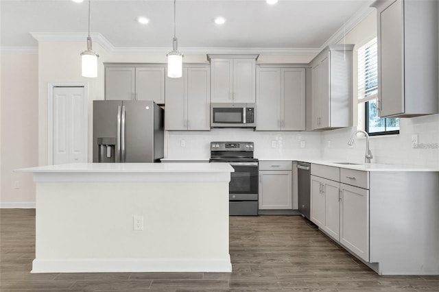 11258 Whistling Pine Way, Orlando, FL 32832 - kitchen featuring appliances with stainless steel finishes, a sink, gray cabinets, crown molding, and decorative backsplash