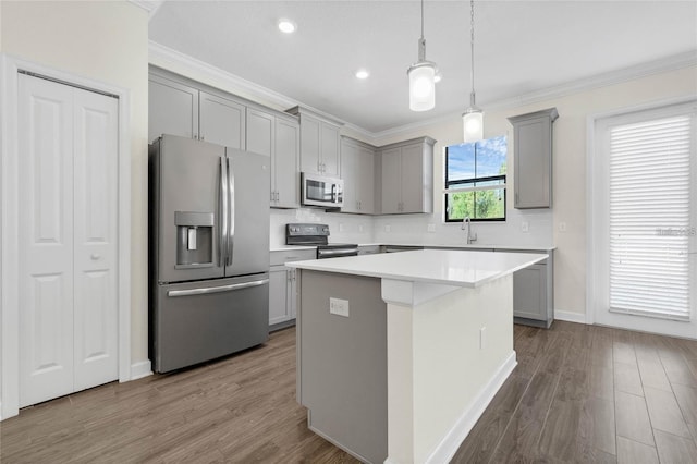 11258 Whistling Pine Way, Orlando, FL 32832 - kitchen with stainless steel appliances, gray cabinetry, crown molding, a kitchen island, and dark wood finished floors