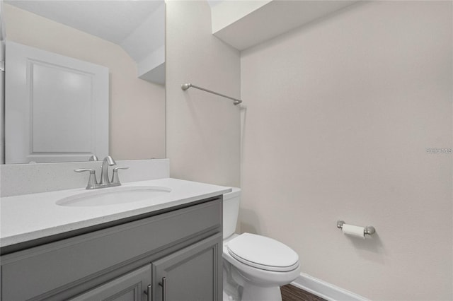 11258 Whistling Pine Way, Orlando, FL 32832 - half bath featuring toilet, vanity, baseboards, and wood finished floors
