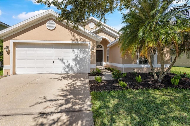 3078 Mandolin Dr, Kissimmee, FL 34744 - view of front facade featuring driveway, stucco siding, and an attached garage