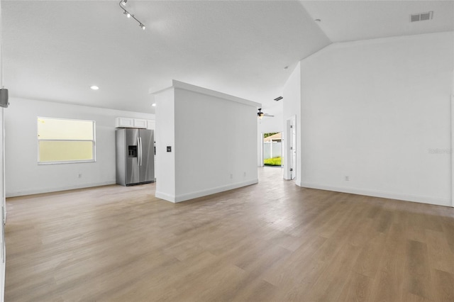 3078 Mandolin Dr, Kissimmee, FL 34744 - unfurnished living room with a ceiling fan, vaulted ceiling, light wood finished floors, recessed lighting, and baseboards