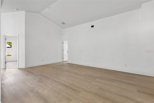 3078 Mandolin Dr, Kissimmee, FL 34744 - empty room with high vaulted ceiling, light wood-style flooring, and baseboards