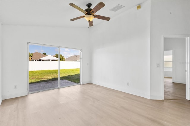 3078 Mandolin Dr, Kissimmee, FL 34744 - spare room with light wood-style floors, healthy amount of natural light, ceiling fan, baseboards, and high vaulted ceiling