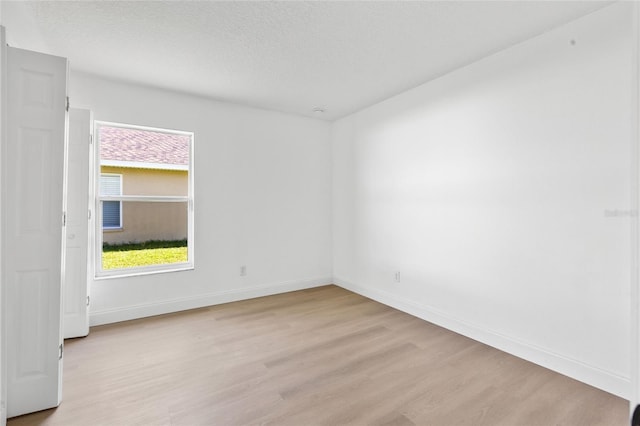 3078 Mandolin Dr, Kissimmee, FL 34744 - spare room featuring light wood finished floors, baseboards, and a textured ceiling