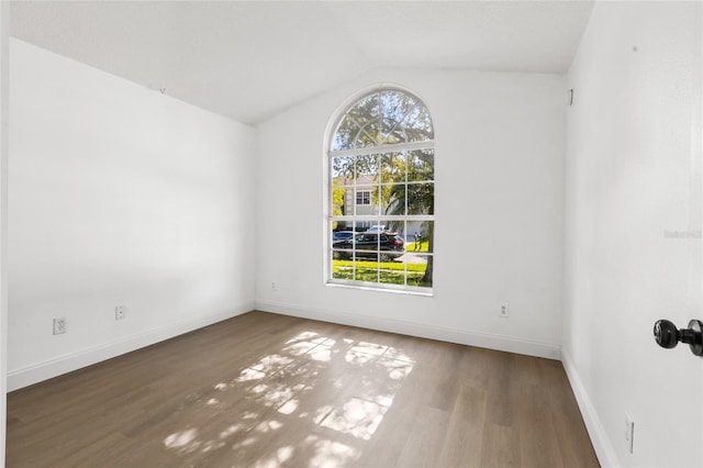 3078 Mandolin Dr, Kissimmee, FL 34744 - unfurnished room featuring wood finished floors, baseboards, and vaulted ceiling
