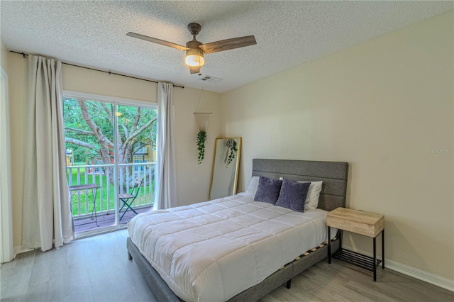 bedroom with wood finished floors, access to outside, a textured ceiling, baseboards, and ceiling fan