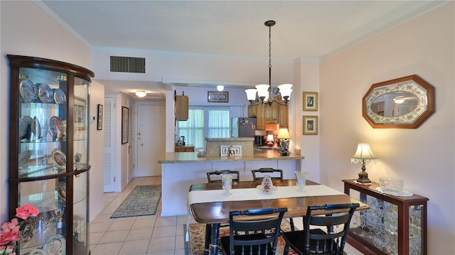 717 S Beach St Unit 205C, Daytona Beach, FL 32114 - dining space with a chandelier, ornamental molding, and light tile patterned floors