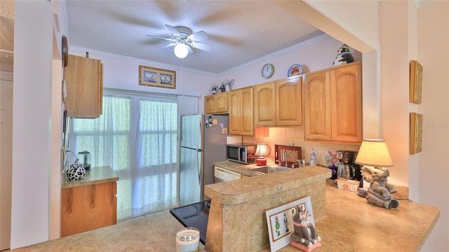 717 S Beach St Unit 205C, Daytona Beach, FL 32114 - kitchen featuring a sink, a ceiling fan, backsplash, stainless steel appliances, and a textured ceiling