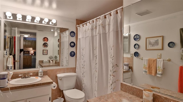 717 S Beach St Unit 205C, Daytona Beach, FL 32114 - bathroom with toilet, vanity, a shower with curtain, and tile walls