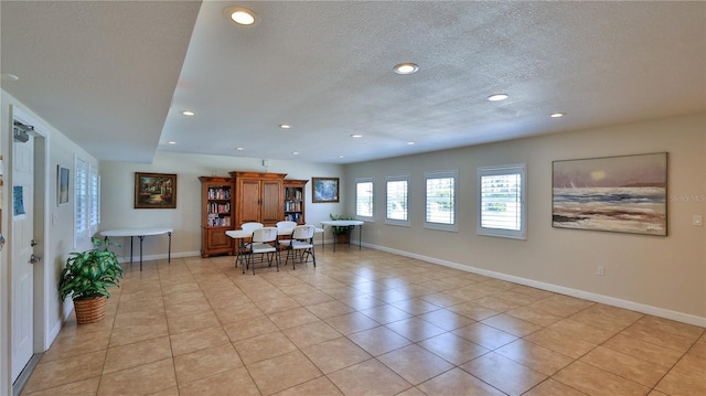 717 S Beach St Unit 205C, Daytona Beach, FL 32114 - dining area with a textured ceiling, recessed lighting, baseboards, and light tile patterned floors
