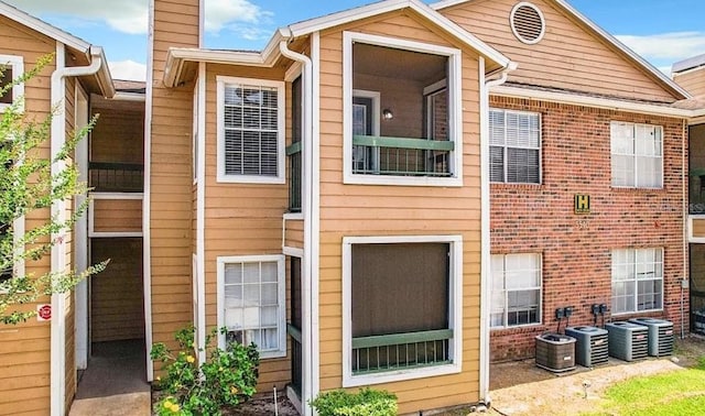 5540 Devonbriar Way Unit 103, Orlando, FL 32822 - view of front of home featuring a chimney, central AC unit, and brick siding