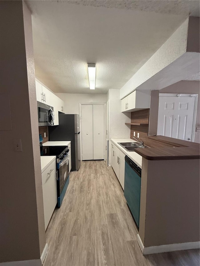 5540 Devonbriar Way Unit 103, Orlando, FL 32822 - kitchen with stainless steel microwave, dishwasher, range with gas stovetop, a sink, and light wood finished floors