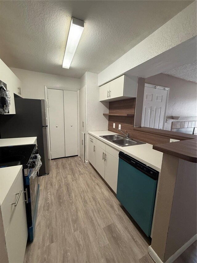 5540 Devonbriar Way Unit 103, Orlando, FL 32822 - kitchen featuring dishwasher, a sink, range with gas stovetop, a textured ceiling, and white cabinetry
