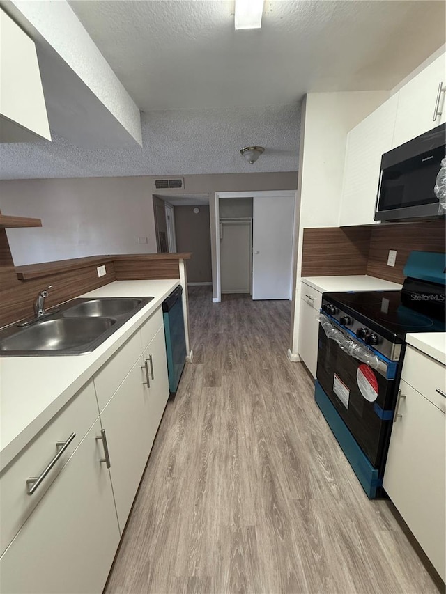 5540 Devonbriar Way Unit 103, Orlando, FL 32822 - kitchen featuring stainless steel microwave, black range with electric stovetop, a sink, dishwasher, and light wood-type flooring